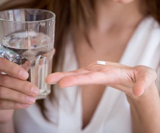 Lady prepares to take pill