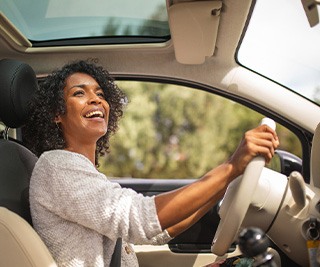 Woman smiling while driving
