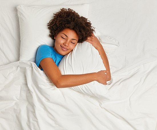Woman sleeping in her bed with sleep apnea in murphy 
