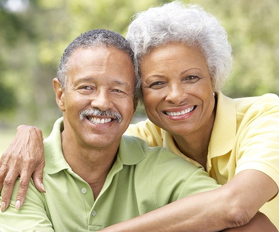 Smiling older man and woman outdoors