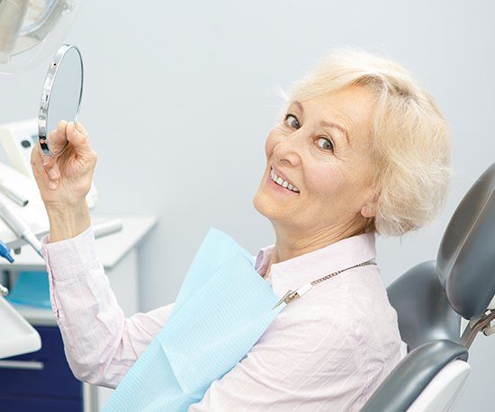 Older woman in dental chair smiling