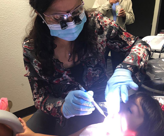 Dentist examining child's smile