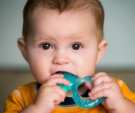 Baby chewing on teething ring