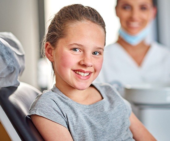 Smiling girl in dental chair