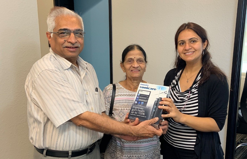 Dentist giving dental patients a free toothbrush