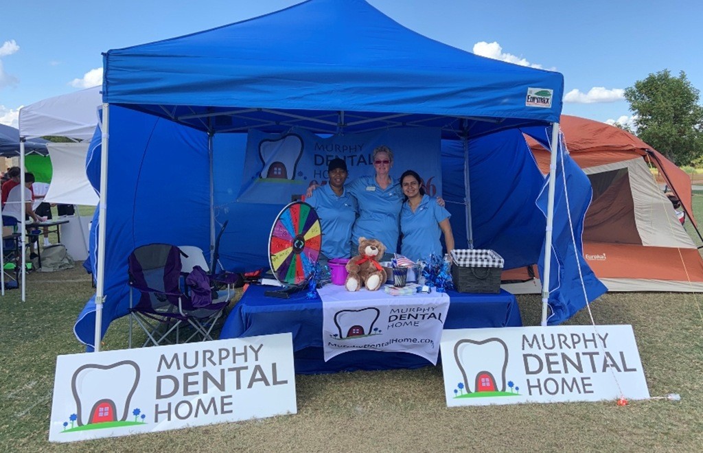 Three dental team members at community event