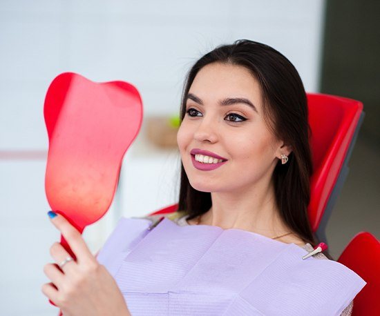 Woman looking at her smile mirror