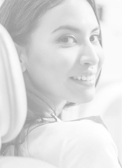 Black and white image of smiling female dental patient