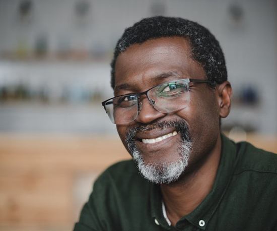 a man smiling with brand new dentures