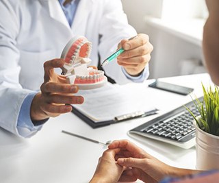 a dentist speaking with a patient about dentures