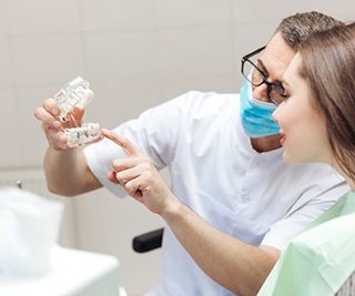 a dentist explaining how dental implants work