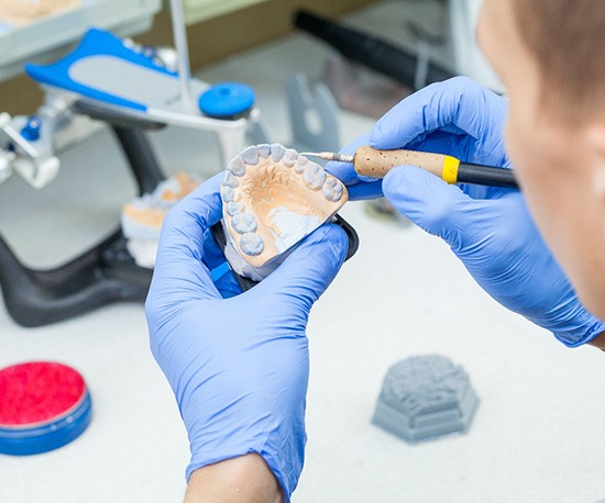 Lab technician carving dentures