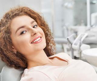 Happy woman attending preventive appointment with her dentist in Murphy