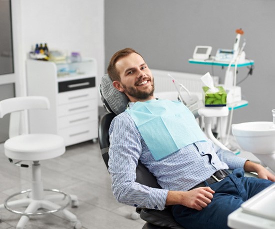 Male dental patient leaning back in dental chair