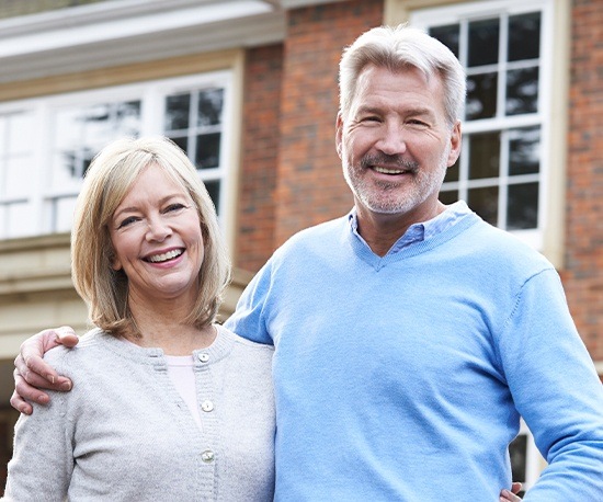 Smiling older man and woman outdoors