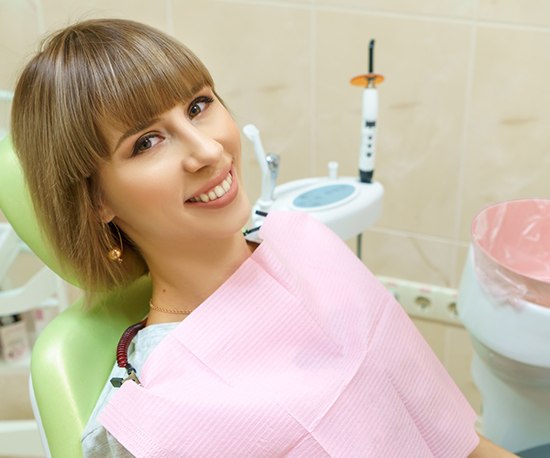 Smiling dental patient in treatment chair