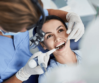a patient with dental implants undergoing a checkup and cleaning