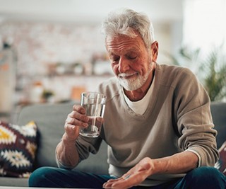 a mature man preparing to take a pill