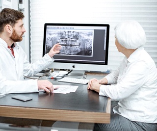 implant dentist in Murphy showing a patient their X-rays
