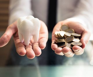 fake tooth in one hand, coins in the other 