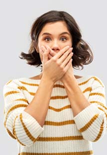 young woman with hand over mouth 