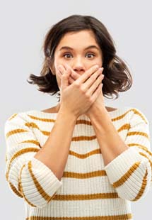 young woman with hand over mouth 