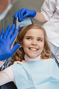 child giving dentist high-five near Wylie