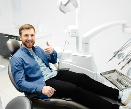 Male patient giving thumbs up for dental ozone therapy