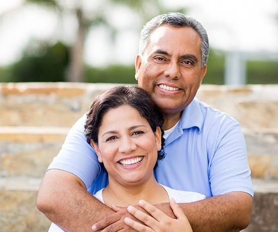 Smiling older man and woman outdoors