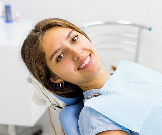 Woman in dental chair smiling