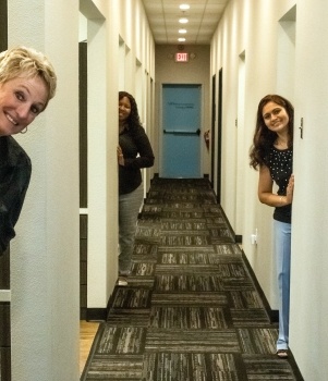 Team members in hallway to dental treatment room in Murphy