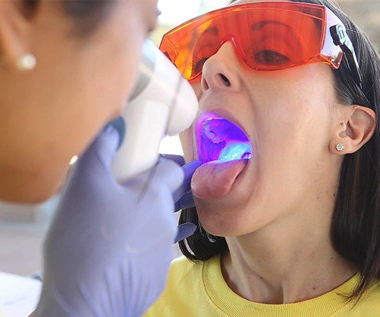 Woman receiving oral cancer screening