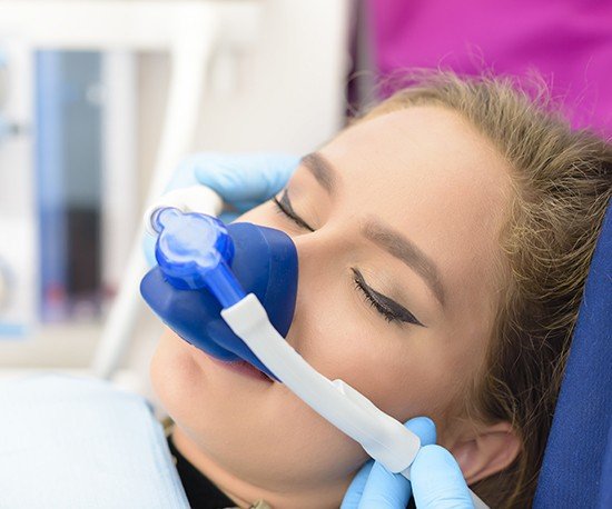 Woman with nitrous oxide nose mask