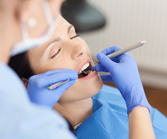 Woman receiving dentistry under general anesthesia