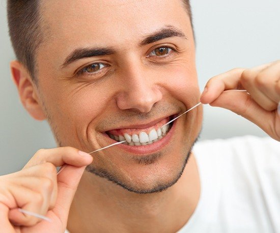 Man flossing his teeth