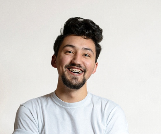 Man smiles with braces in Murphy on white background