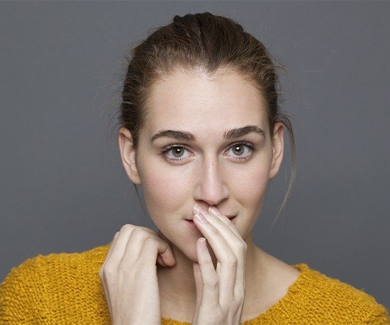 Woman covering her smile