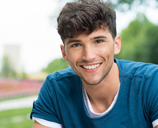 Man smiling after wisdom tooth extraction in Murphy 