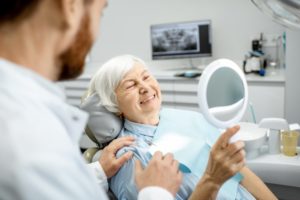 Woman admiring her new dental implants