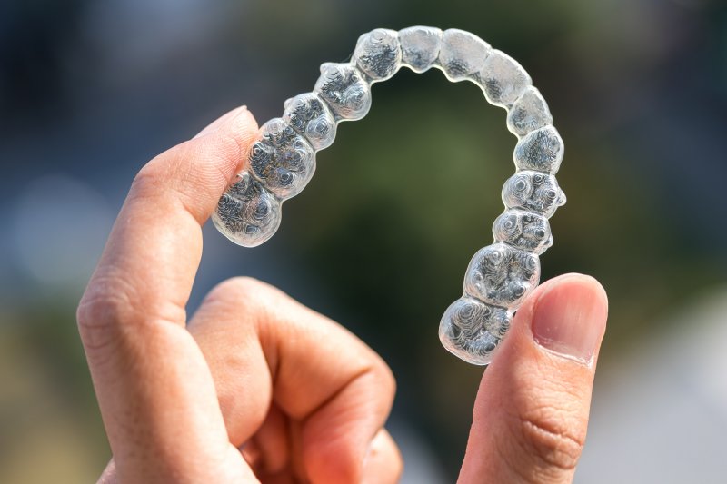 Person holding Invisalign tray