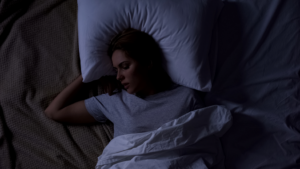 a person struggling to fall asleep at nigh